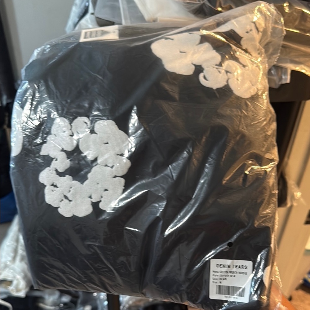 Denim Tears Black Hoodie with White Floral Design